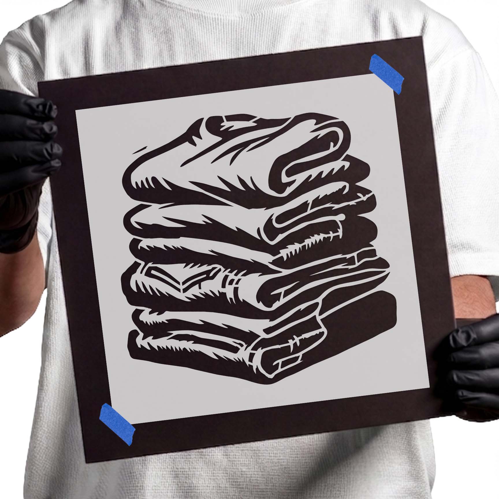 Stack of neatly folded laundry stencil design with layered folded fabric
