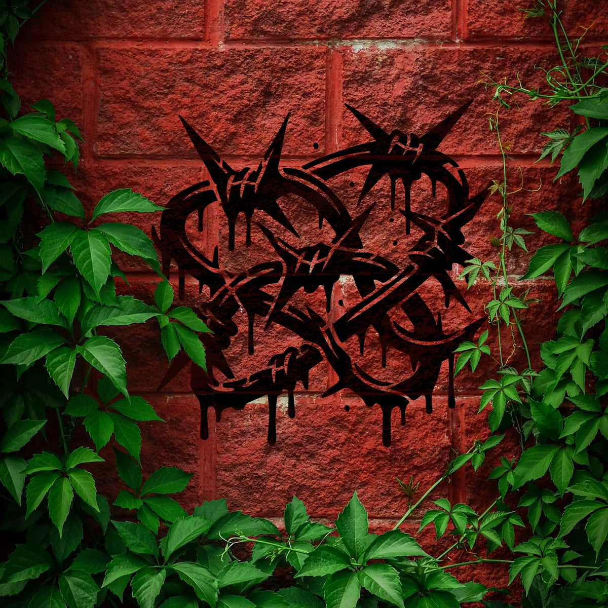 Set on red brick, the Graffiti Barbed Wire Stencil creates a bold black design framed by ivy.