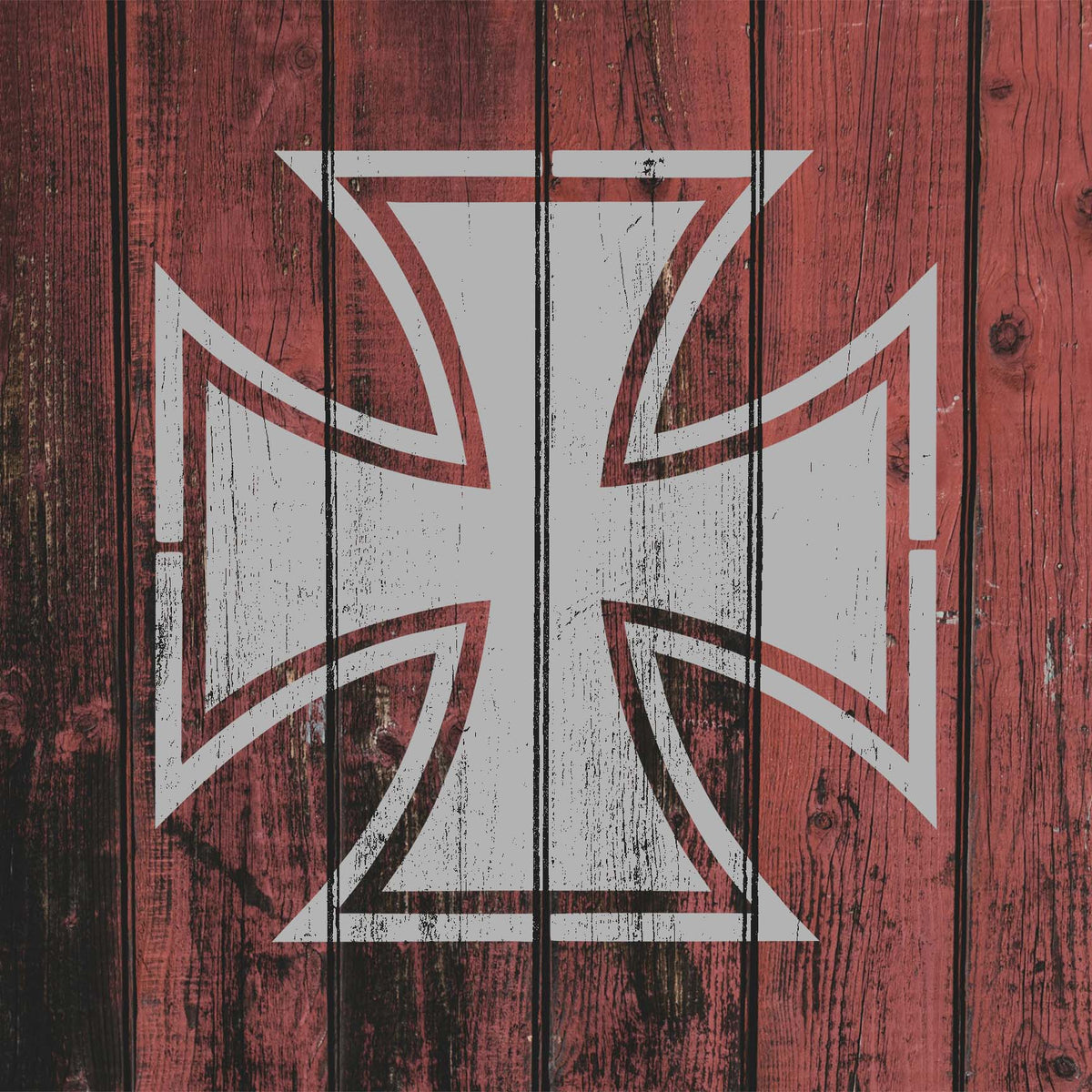 Weathered Iron Cross Stencil in white stands out against rustic red wooden boards