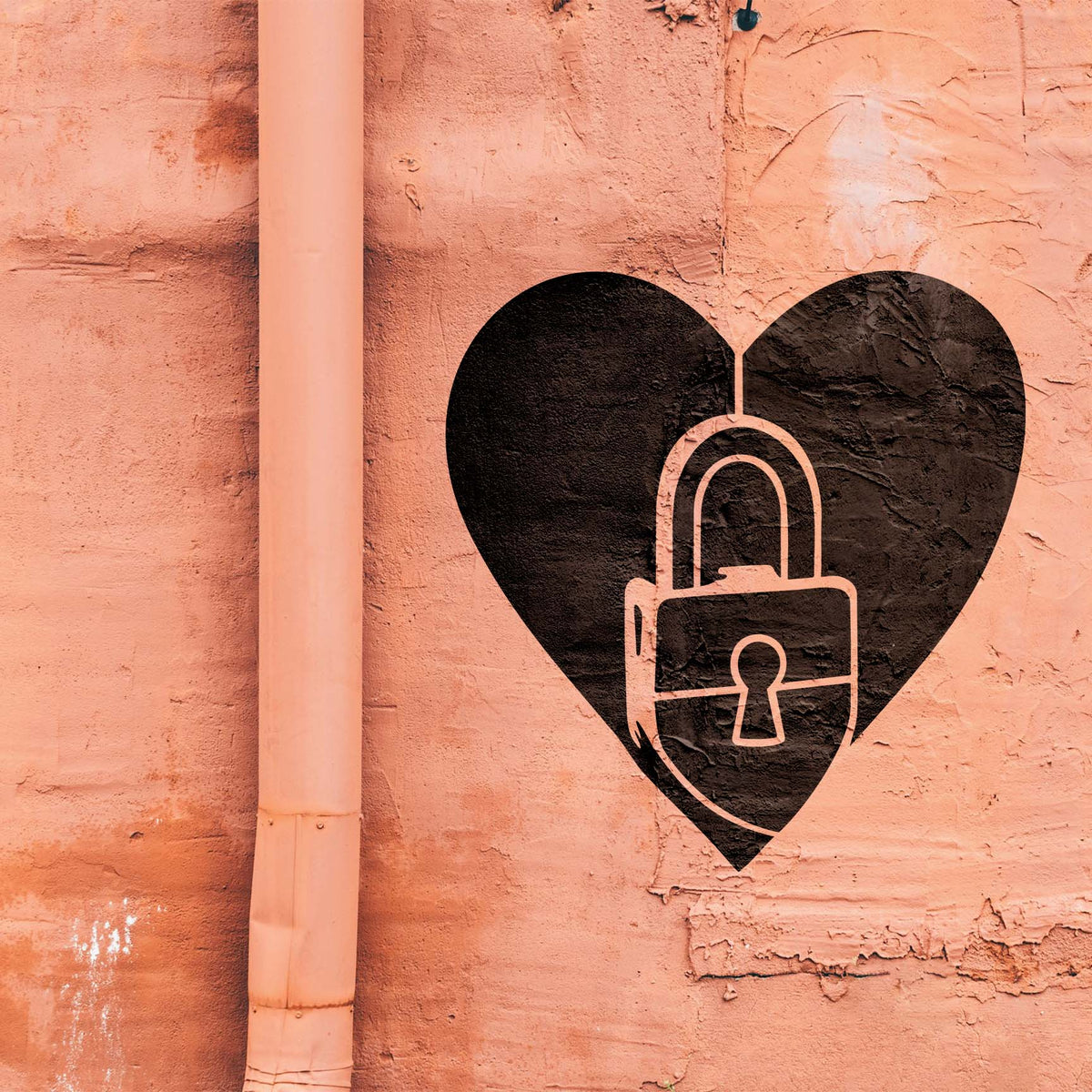 Love Lock Heart Stencil painted black with a padlock detail on a textured salmon wall