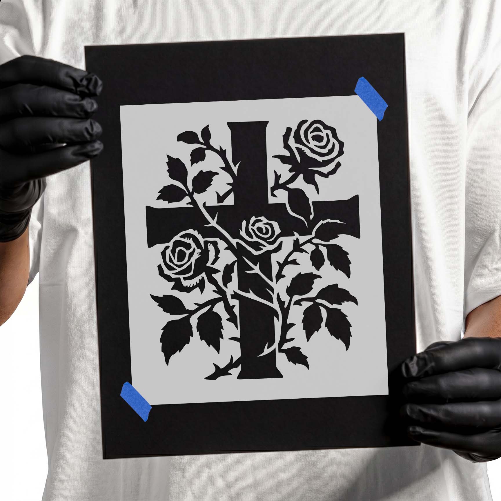 Cross entwined with blooming rose vines and detailed leaves
