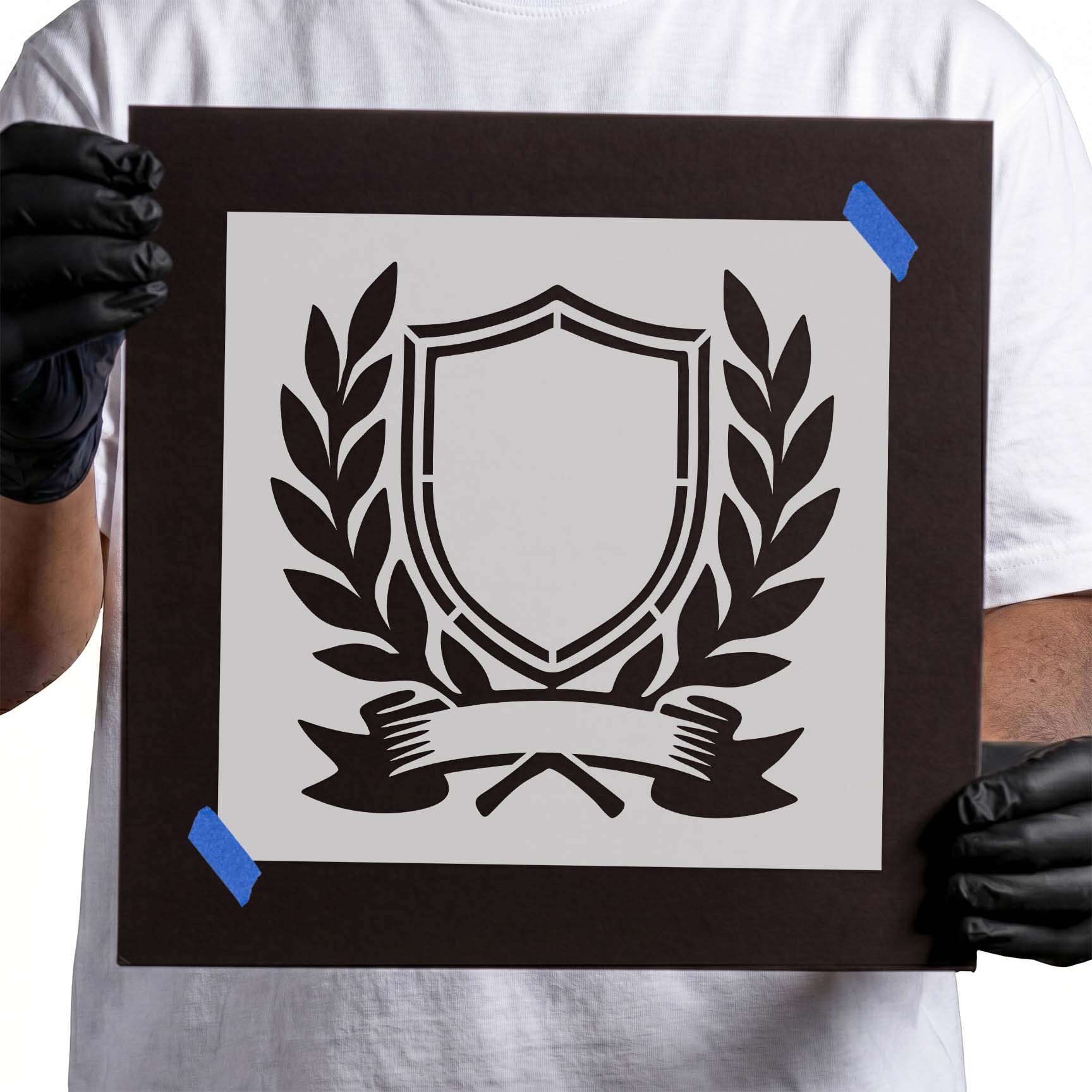 Service crest featuring a shield, laurel branches, and ribbon banner
