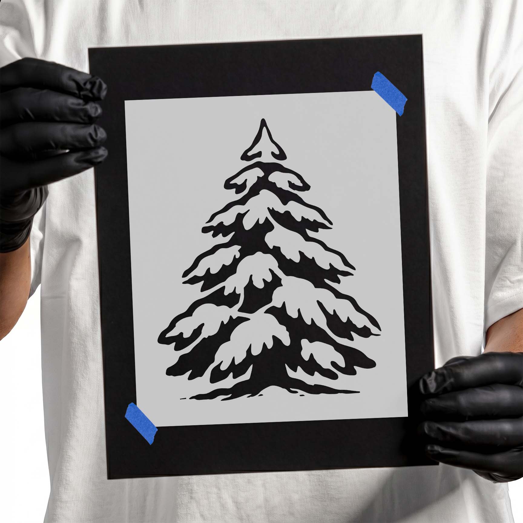 Snow-covered evergreen pine tree with layered winter branches.
