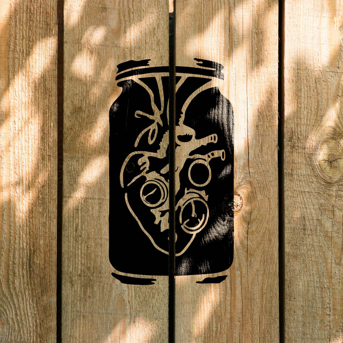 Rustic wood features the Steampunk Anatomical Heart Jar Stencil with detailed black artwork.
