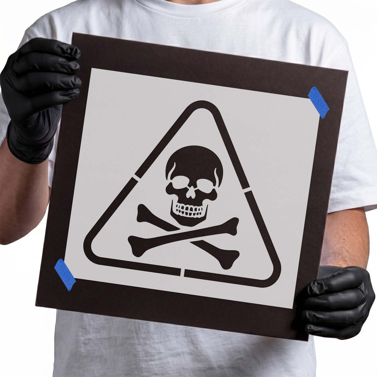 Toxic waste stencil with skull and crossbones enclosed in a triangular hazard warning symbol
