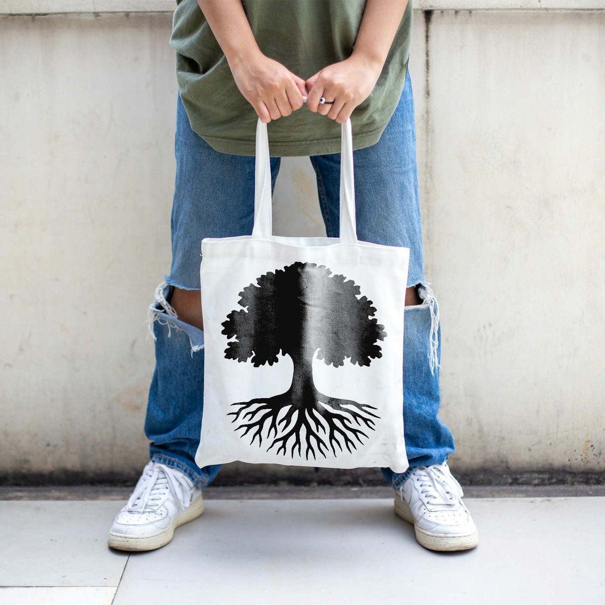 Striking tree roots stencil with broad canopy printed on a white tote bag