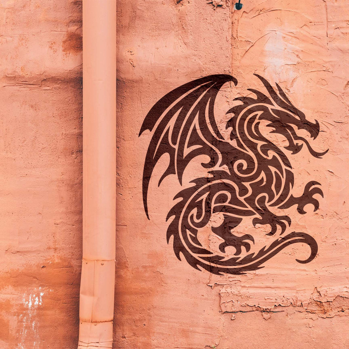 A fierce Tribal Fire Dragon Stencil in dark brown features sweeping wings and curling flames on a peach wall.