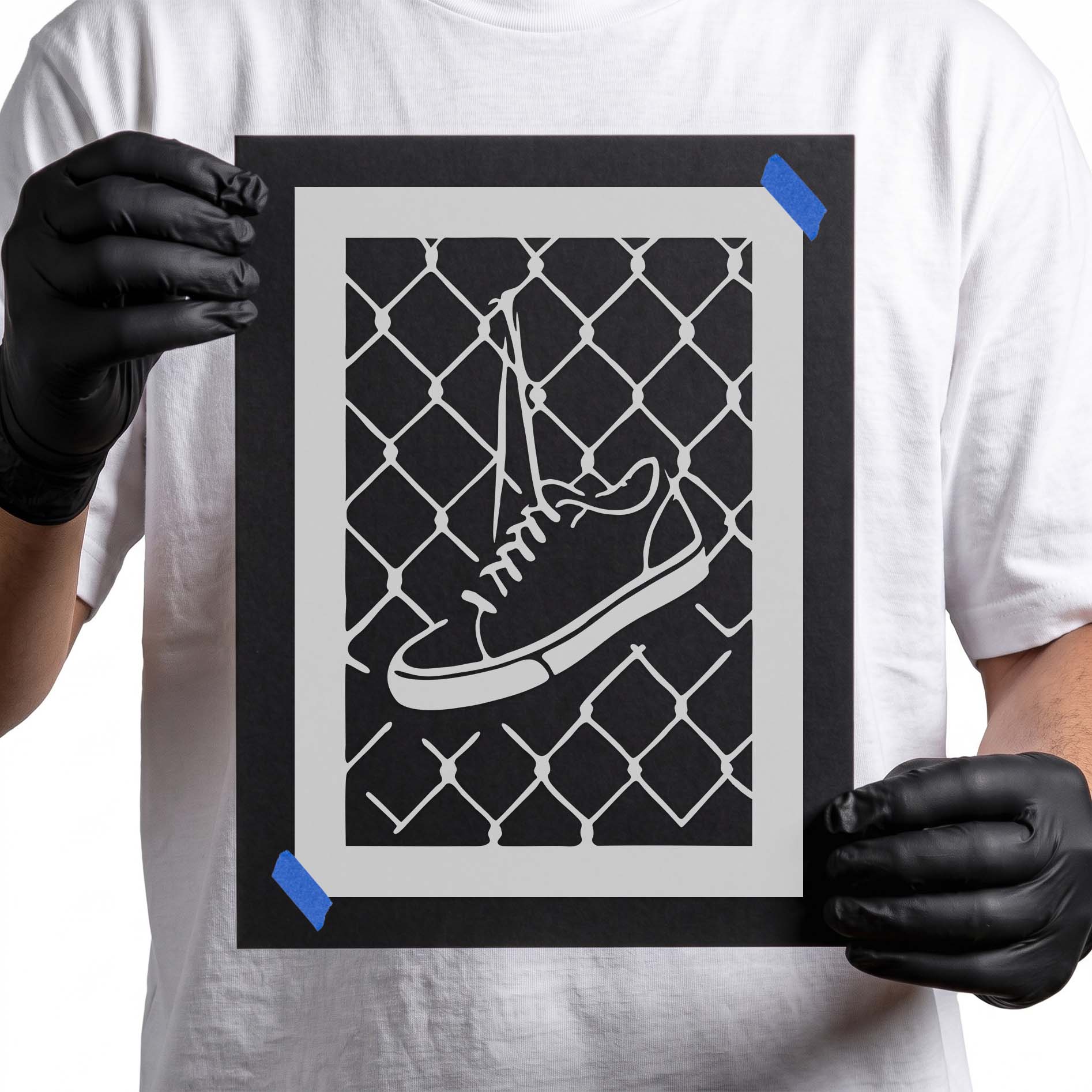 Hanging sneaker on a chain link fence stencil design
