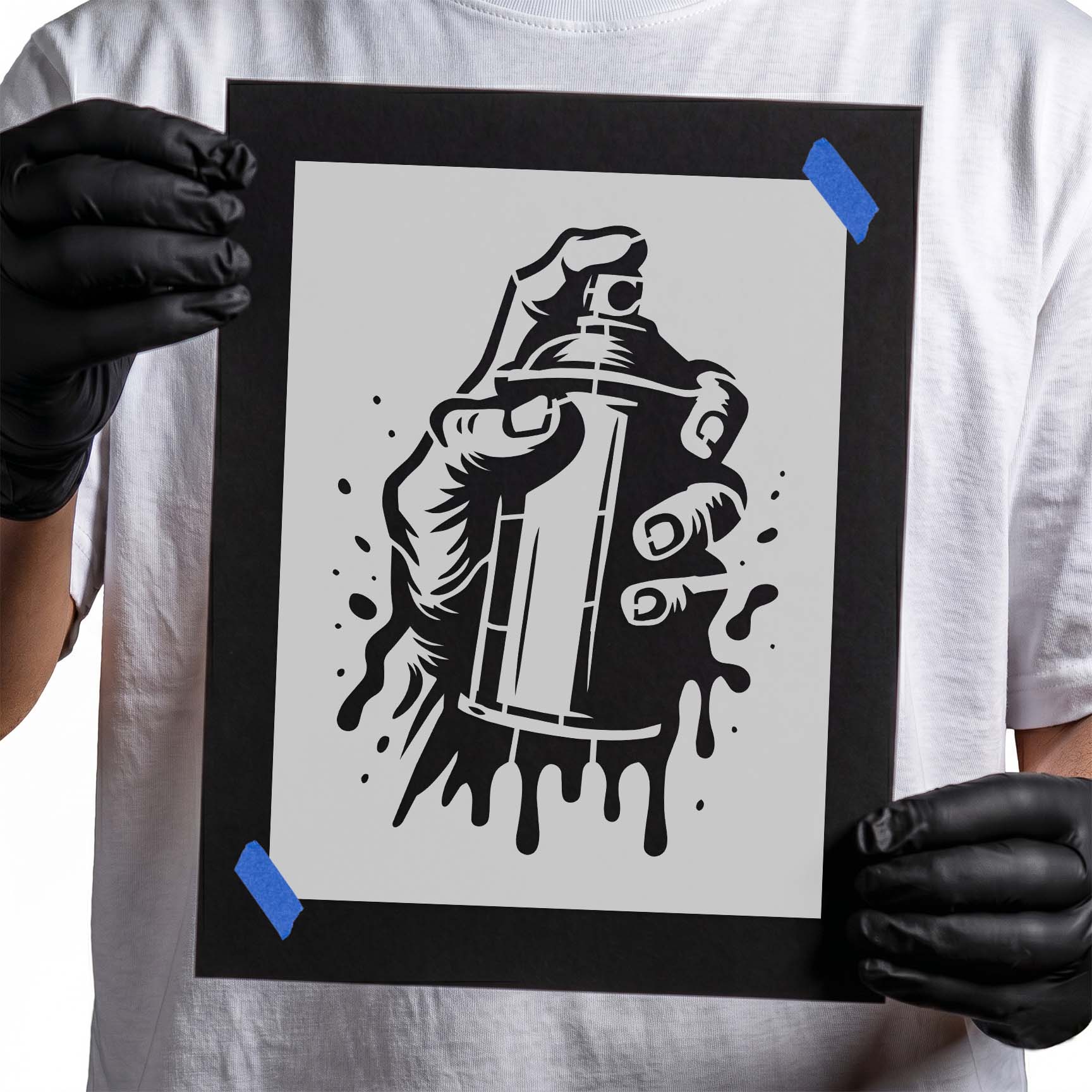 Hand holding spray paint can stencil with paint drips