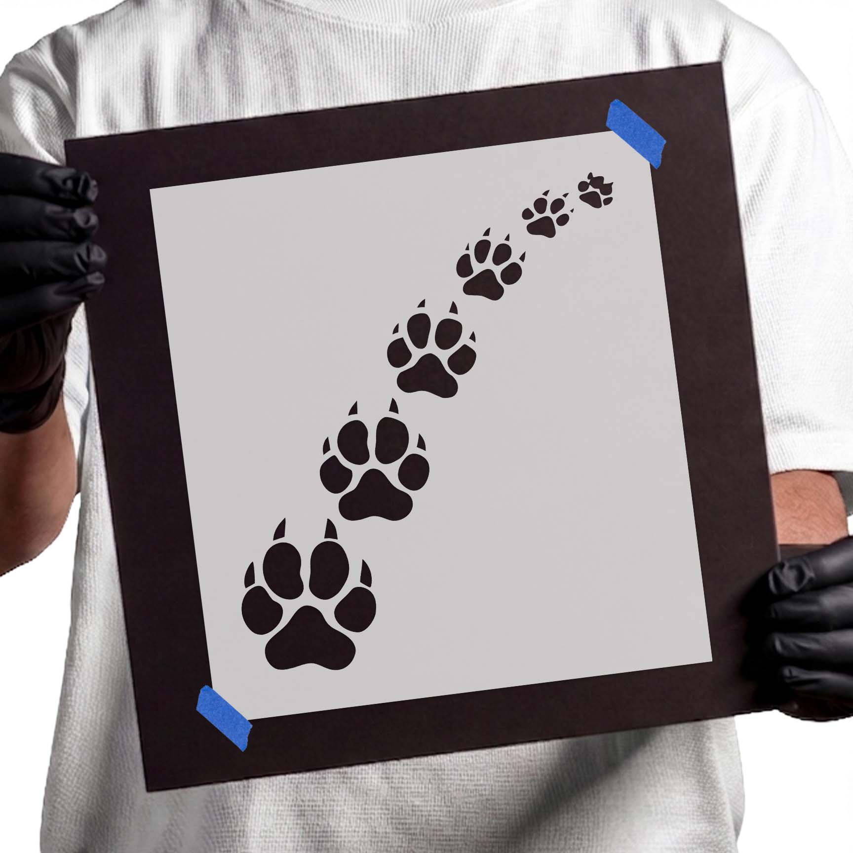Trail of gradually sized wild animal paw prints stencil design