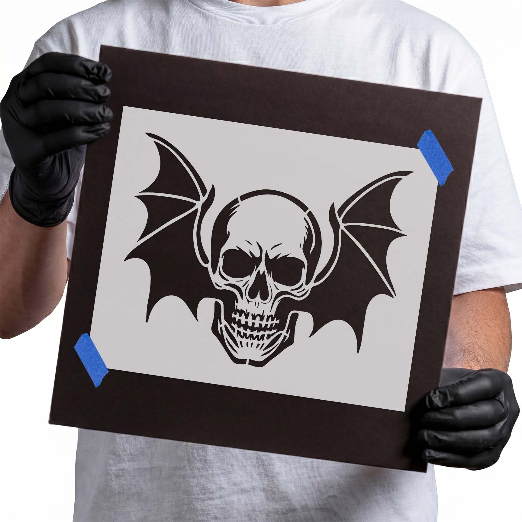 Realistic skull with spread bat-like wings stencil design
