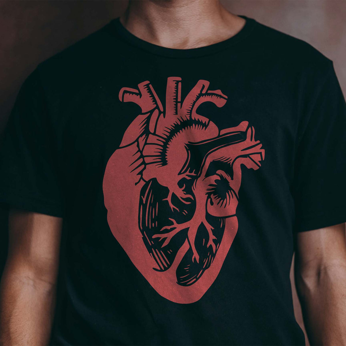 Bold red Anatomical Heart Stencil adds a detailed human heart graphic to a black T-shirt