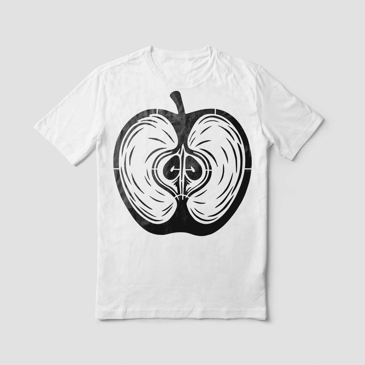 A white T-shirt features the Apple Cross Section Stencil in bold black with detailed seed patterns.