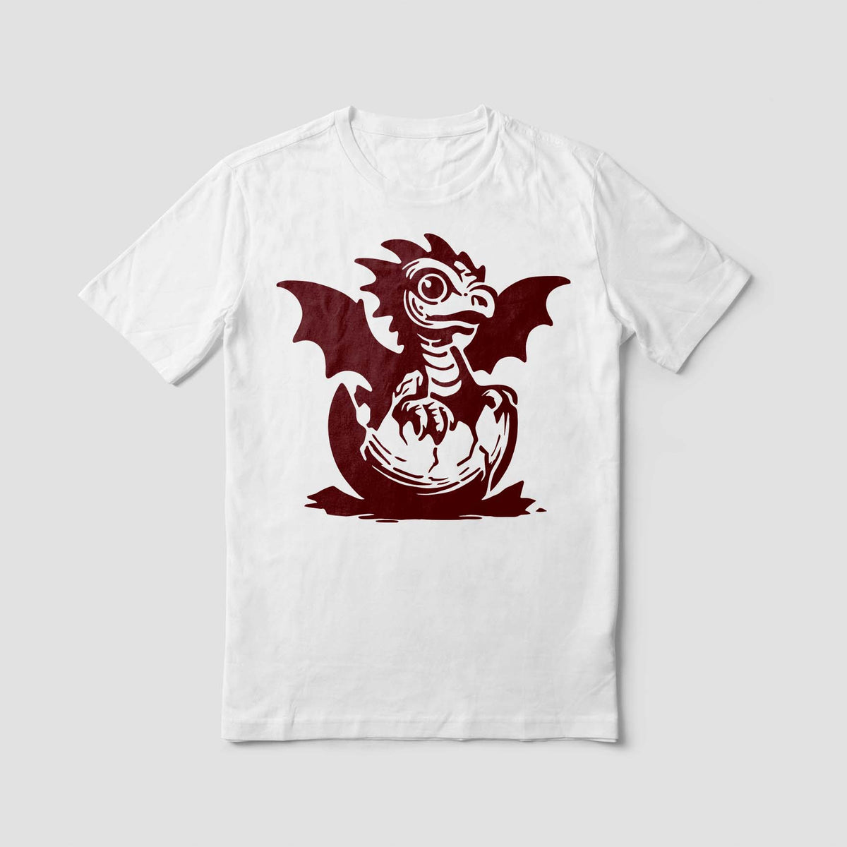 With tiny claws and spread wings, the Baby Dragon Hatching Stencil adds a charming red design to a white shirt.