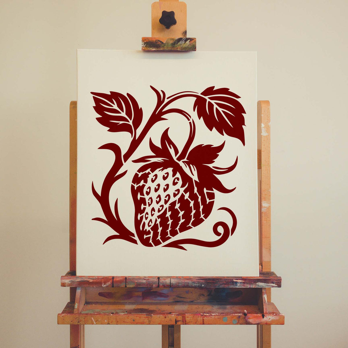 On a white canvas, Botanical Strawberry Vine Stencil reveals a red berry with curling stems and leaves.