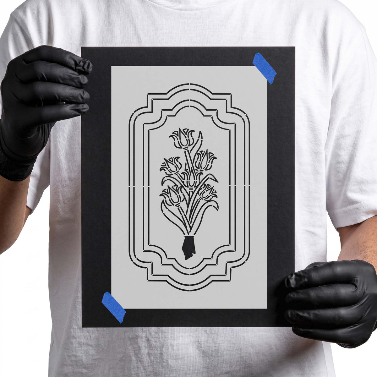 Floral bouquet stencil centered within a layered ornamental border