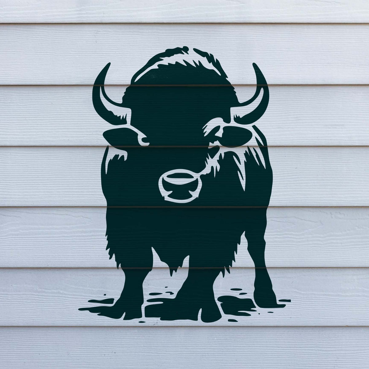 Front Facing Bison Stencil painted dark green on white siding with a bold horned bison design.