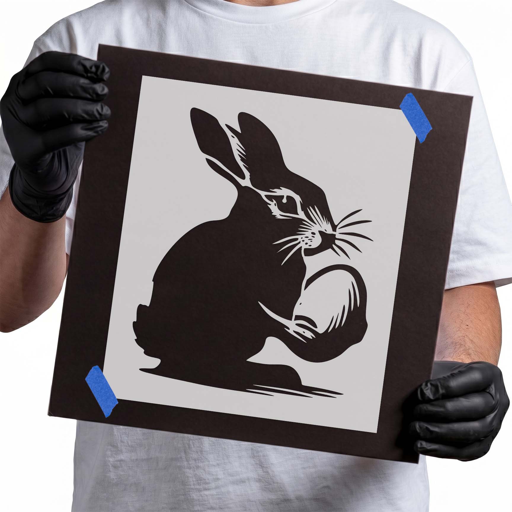 Bunny stencil showing a seated rabbit holding a decorated Easter egg