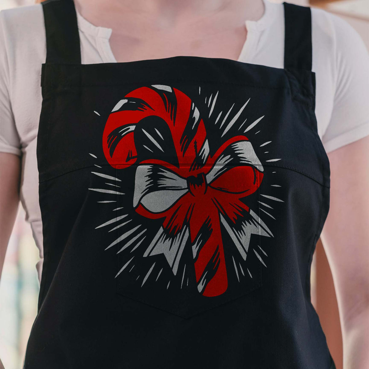 Candy Cane with Radiant Ribbon Stencil stands out in red and silver on a black apron