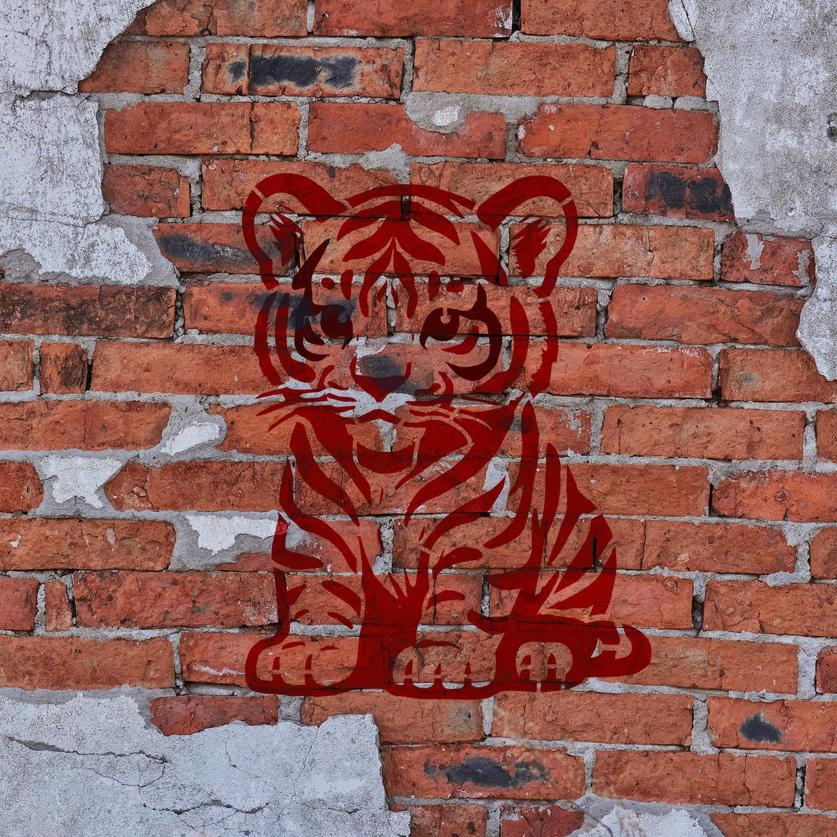 Cartoon Tiger Cub stencil painted red on a rustic exposed brick wall