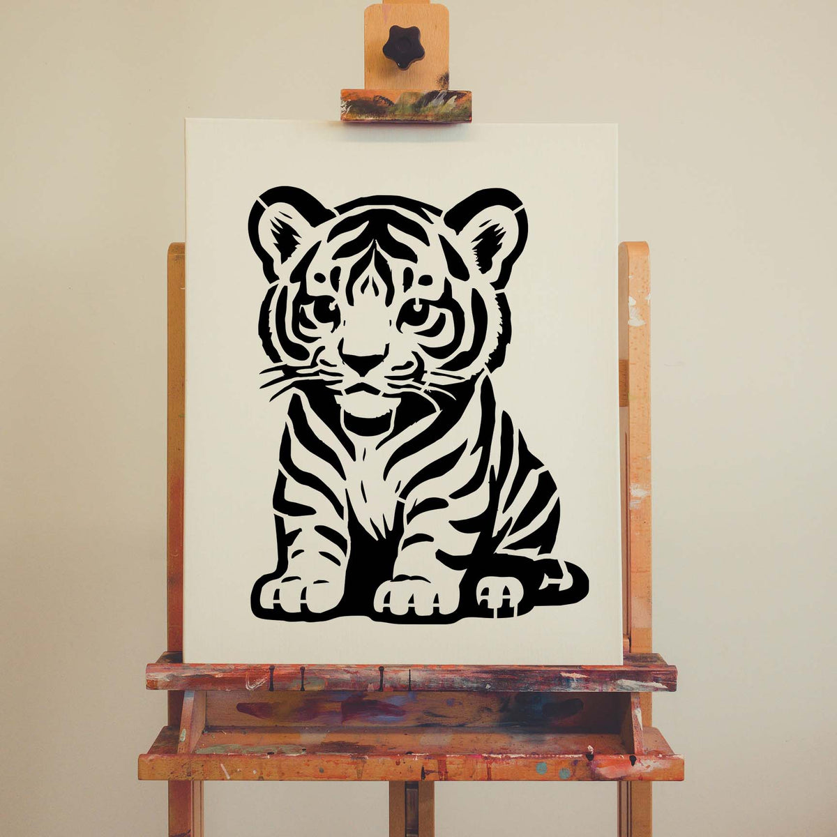 A playful striped cub with rounded ears appears in the Cartoon Tiger Cub Stencil on white canvas.