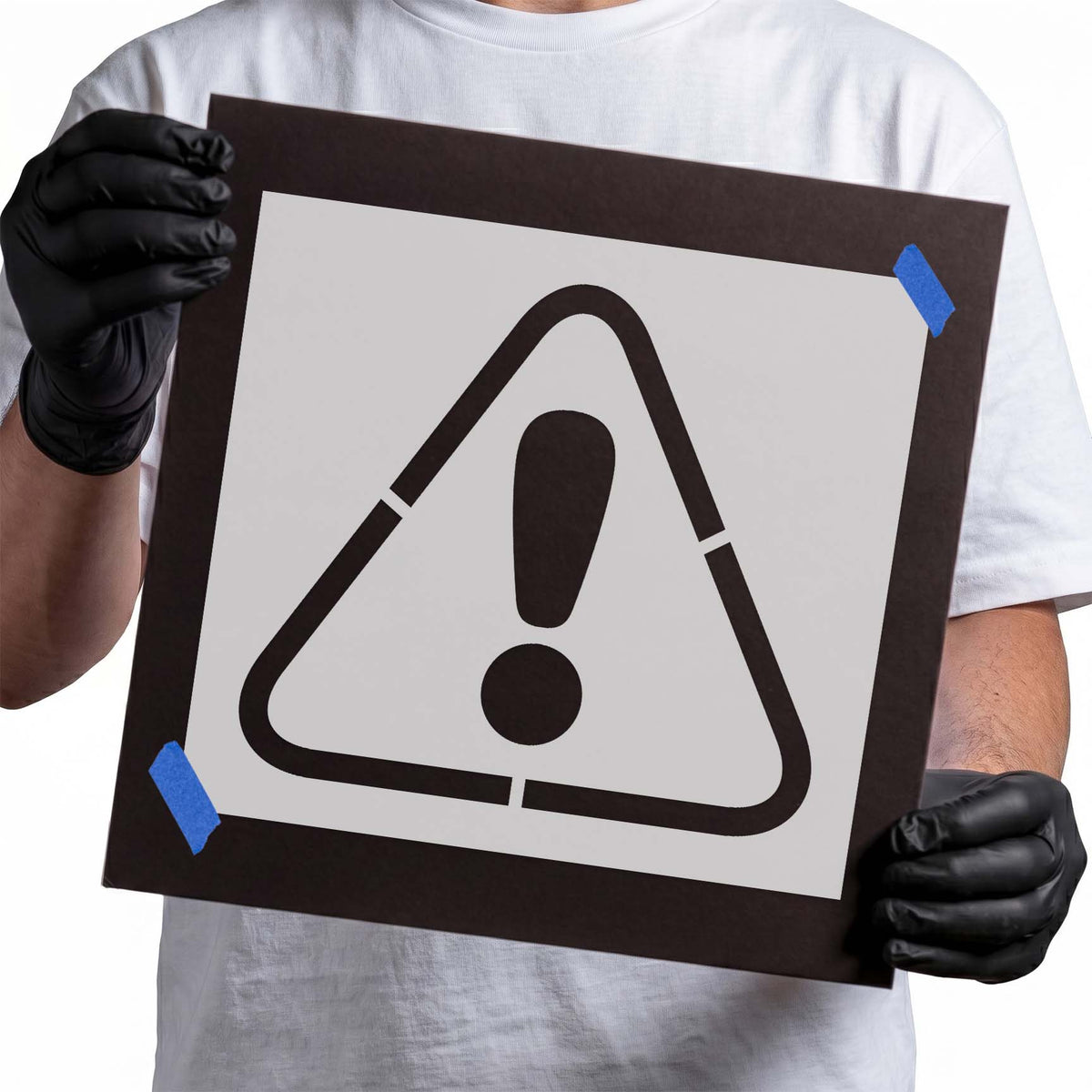 Triangular caution stencil with bold exclamation mark warning symbol