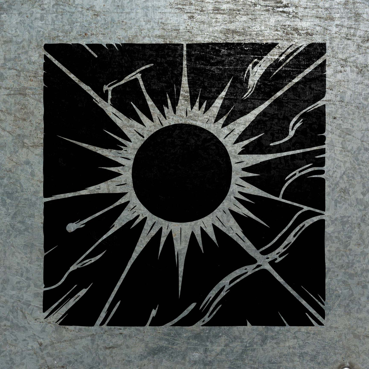 Radiating sun rays define the Celestial Corona Stencil in black on weathered metal.
