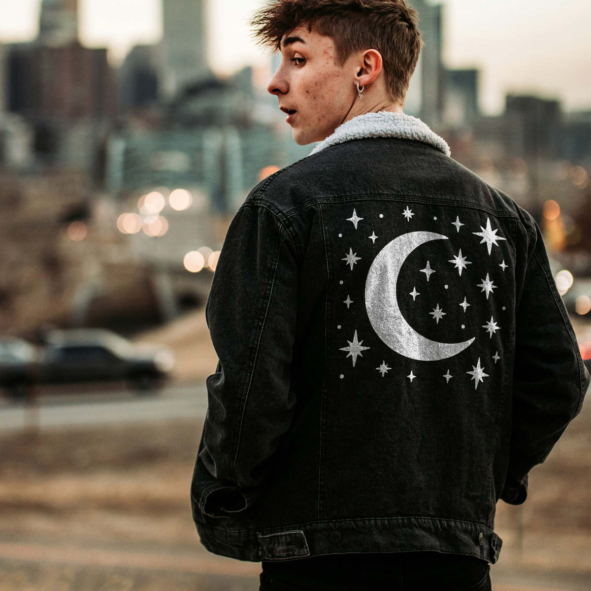 A black denim jacket features the Celestial Crescent Moon and Twinkling Stars Stencil in silver.
