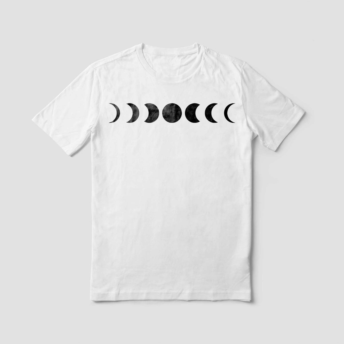 A white T-shirt features the Celestial Moon Phase Border Stencil with a row of seven black moons.