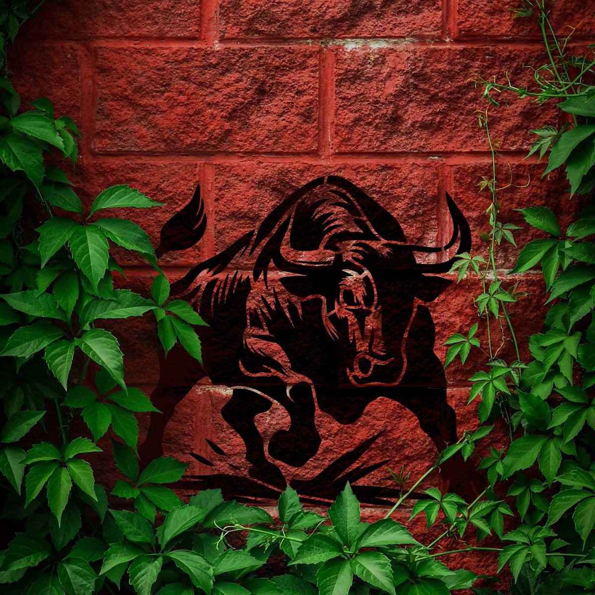 Against a red brick wall, the Charging Bull Silhouette Stencil displays a powerful black bull ready to charge.