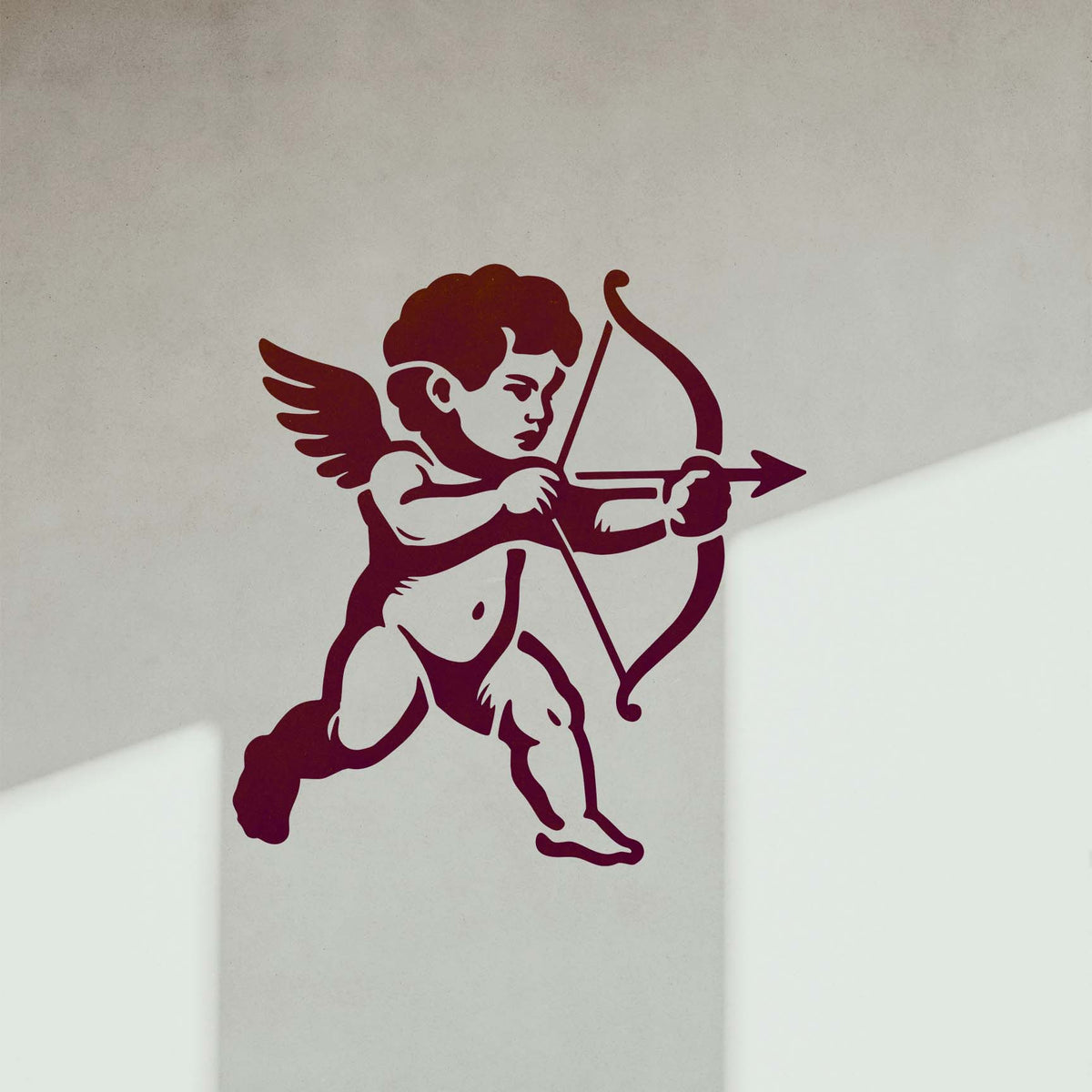 Cupid Cherub stencil featuring a winged cherub aiming a bow and arrow painted on a white interior wall