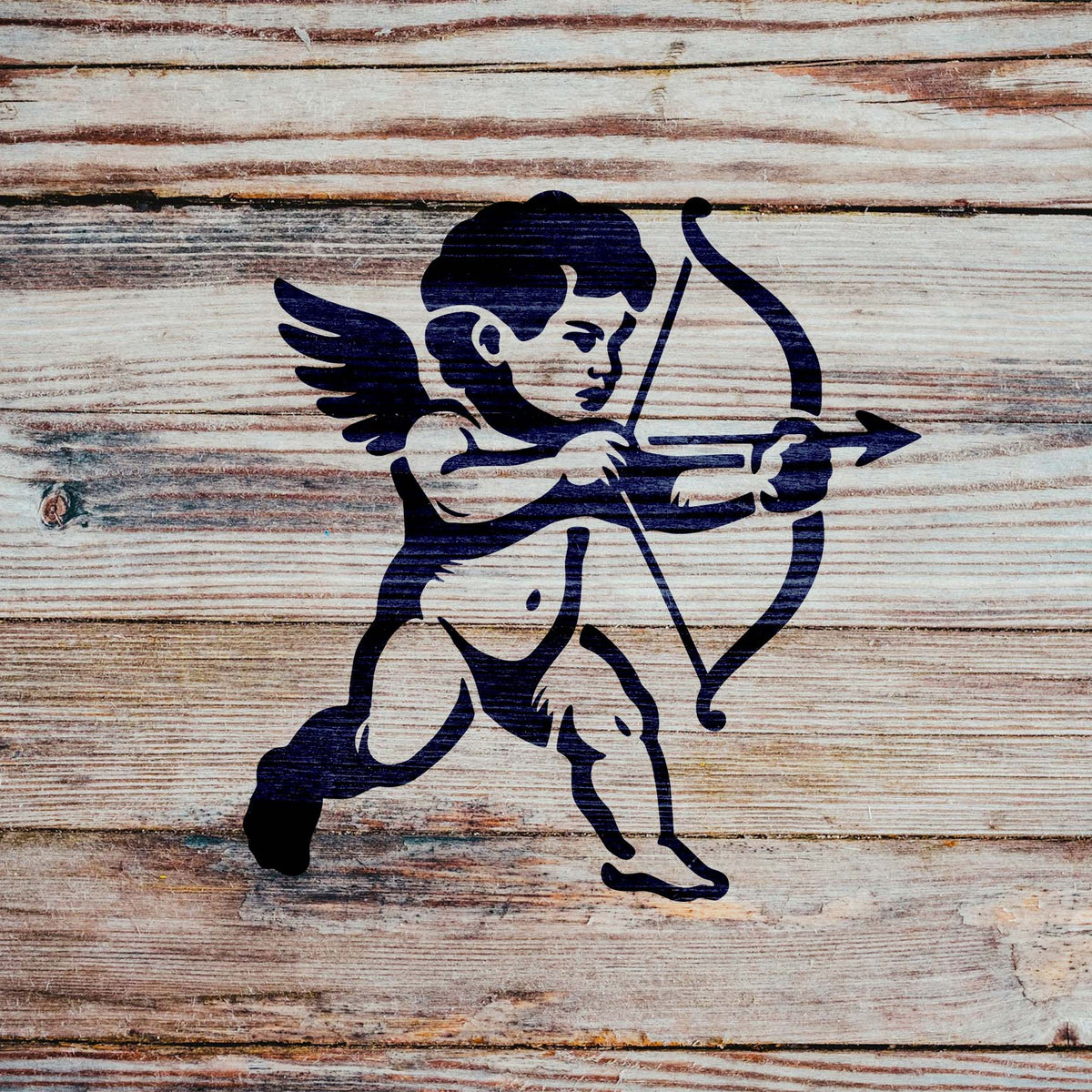 Cupid Cherub stencil with a winged cherub holding a bow and arrow applied to rustic wooden planks