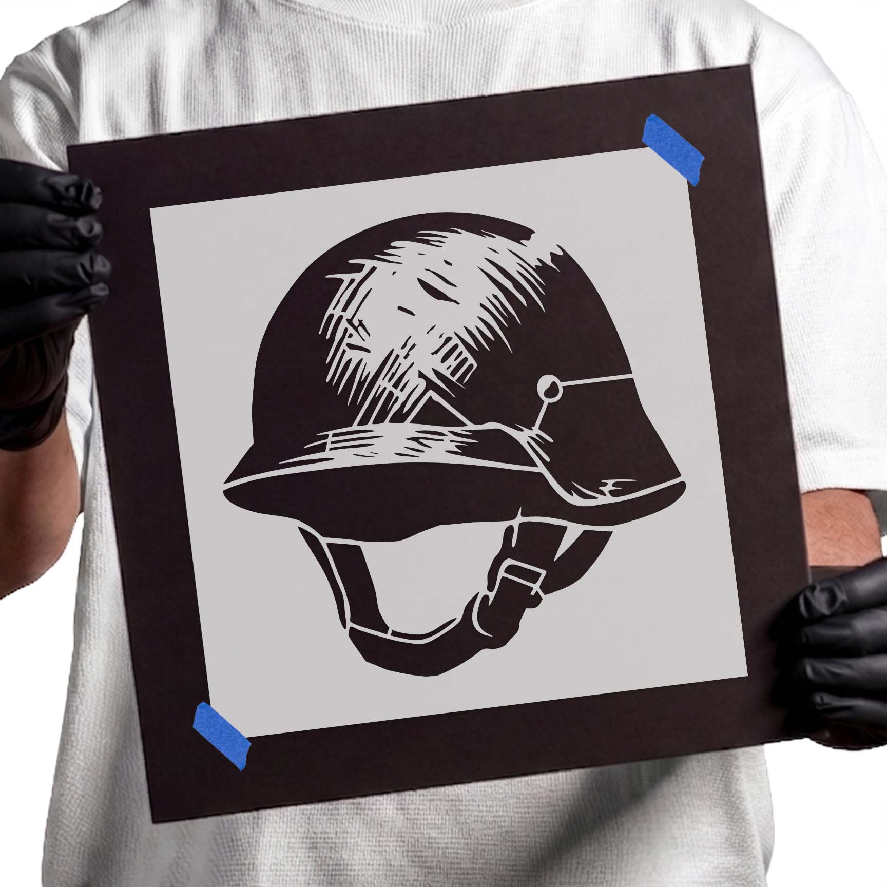 Person holding Classic Military Helmet reusable Mylar stencil