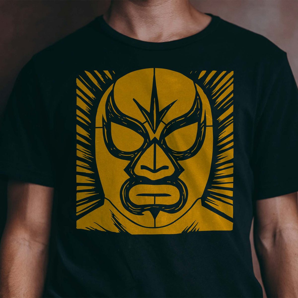 A fierce golden Classic Lucha Libre Wrestling Mask Stencil brings bold Mexican wrestling style to a black shirt.