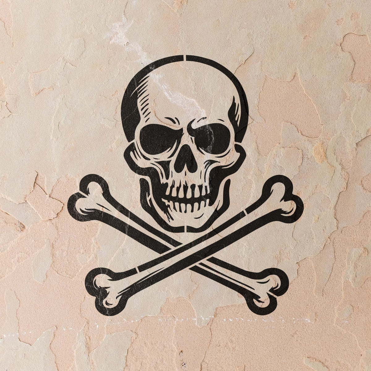 A weathered stucco wall displays the Classic Skull and Crossbones Stencil in crisp black detail.