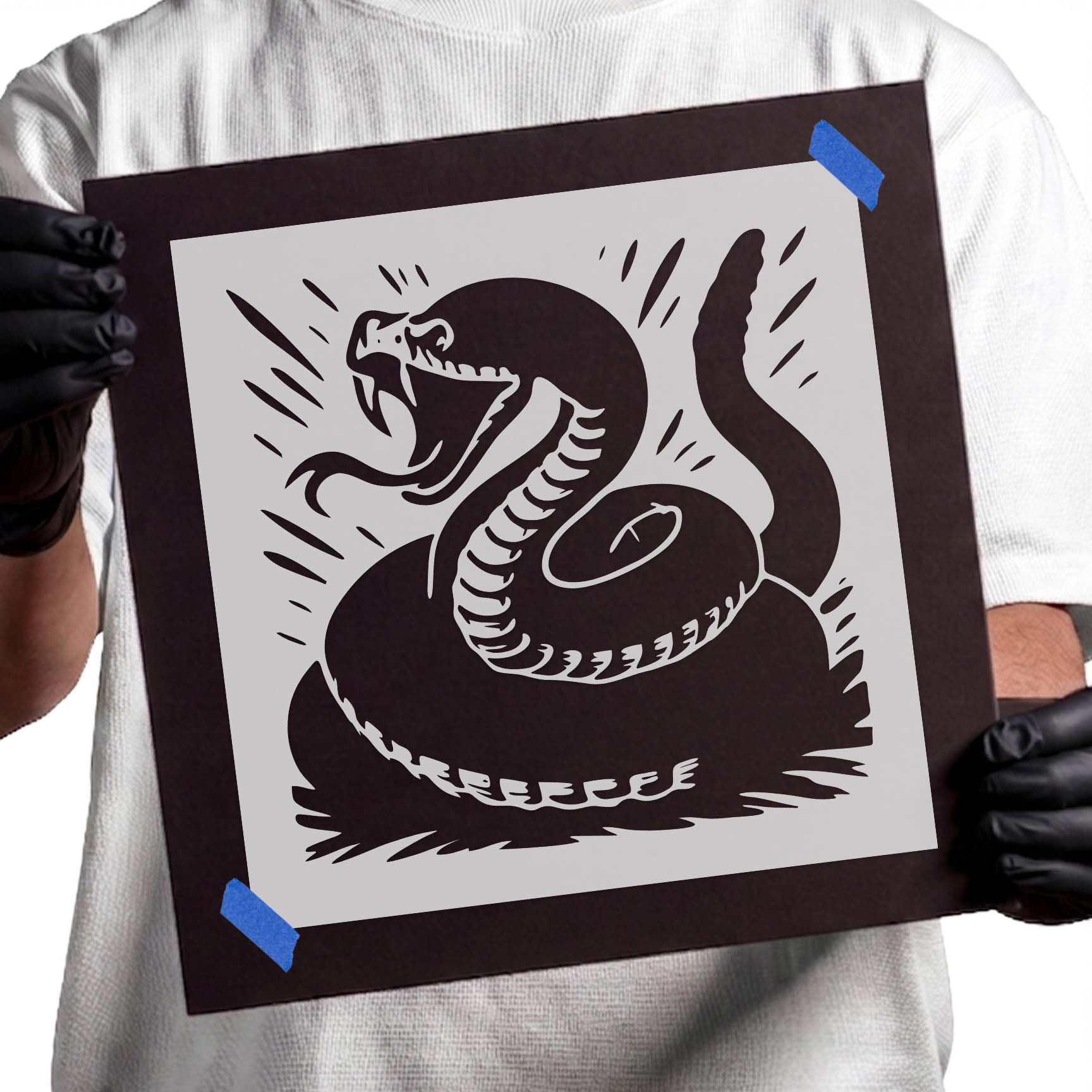 Coiled rattlesnake stencil with open jaws, exposed fangs, and raised rattle