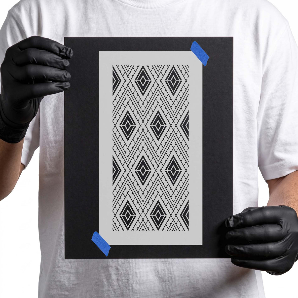 Geometric stencil with repeating layered diamonds, chevrons, and linear details