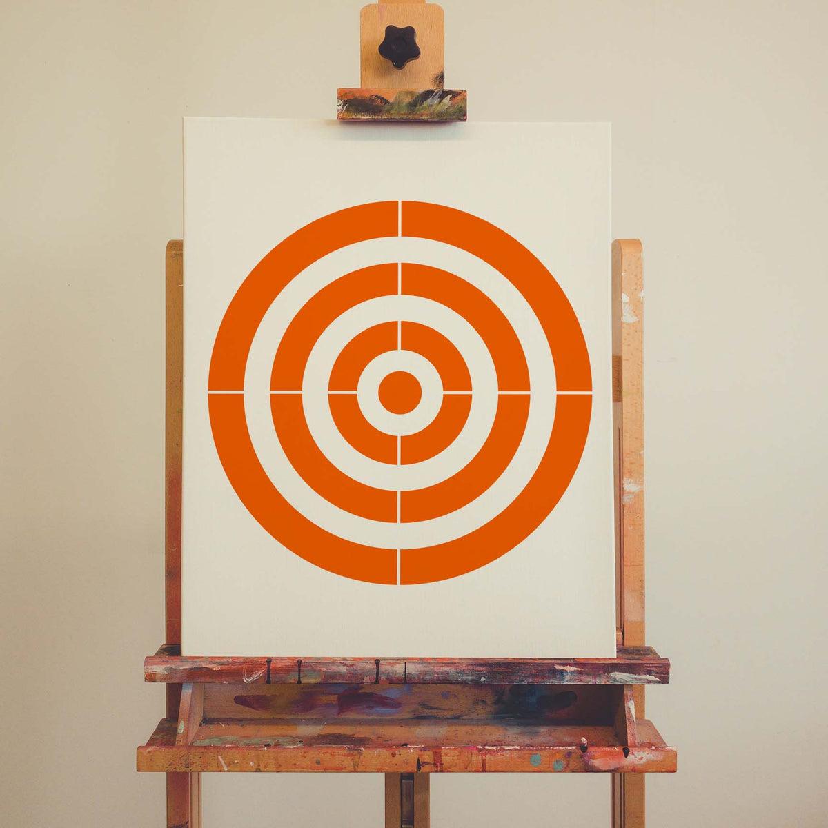 Concentric Circle Target Stencil forms a vivid orange bullseye across a white artist canvas