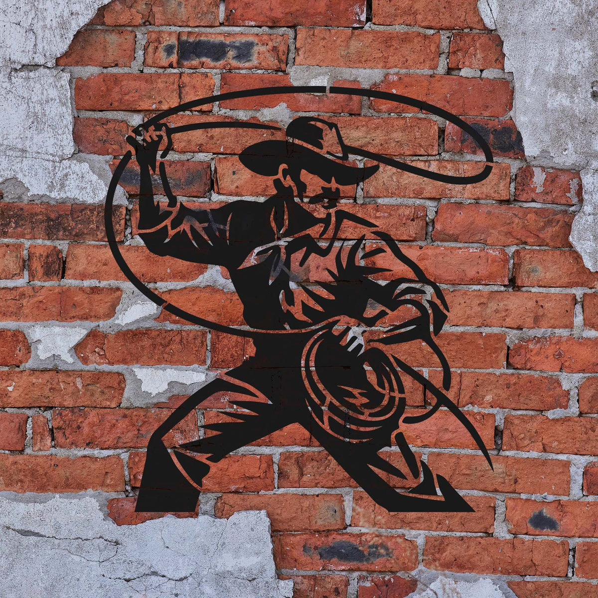 Cowboy Lasso Action Stencil sprayed in black on a weathered red brick wall.