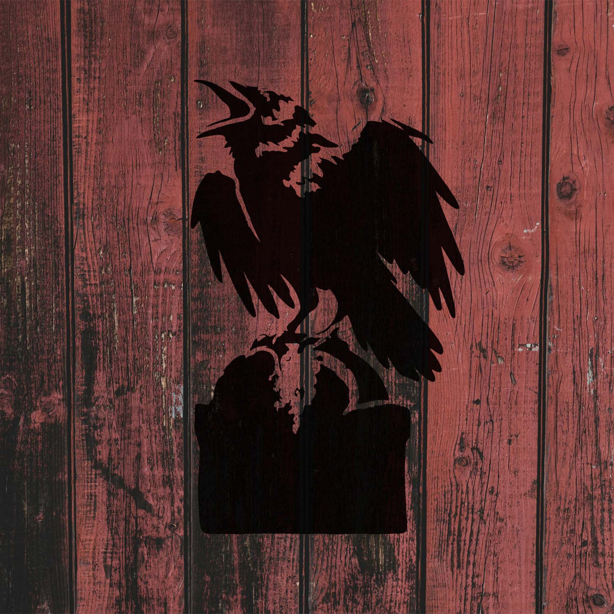 Crow on Tombstone Stencil shown in black on a weathered red wooden fence.