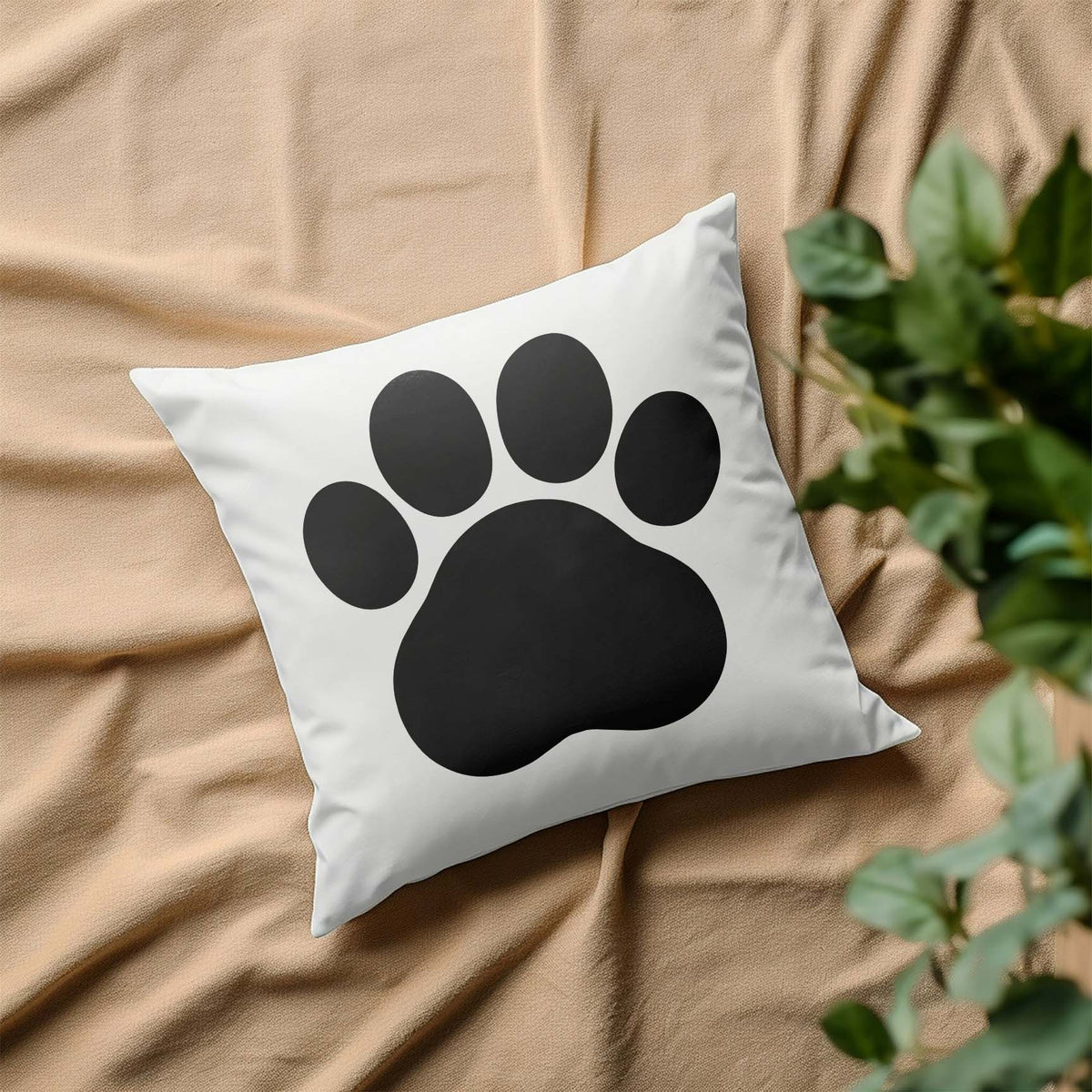White throw pillow featuring the Cartoon Paw Print Stencil in a bold black paw design.