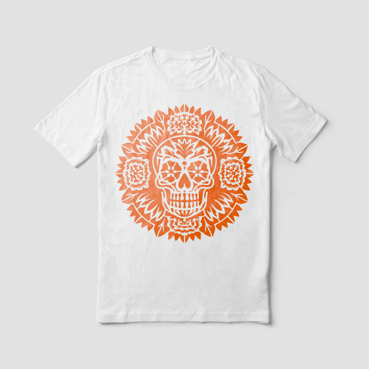A white shirt displays the Day of the Dead Sugar Skull Mandala Stencil in a vivid orange print