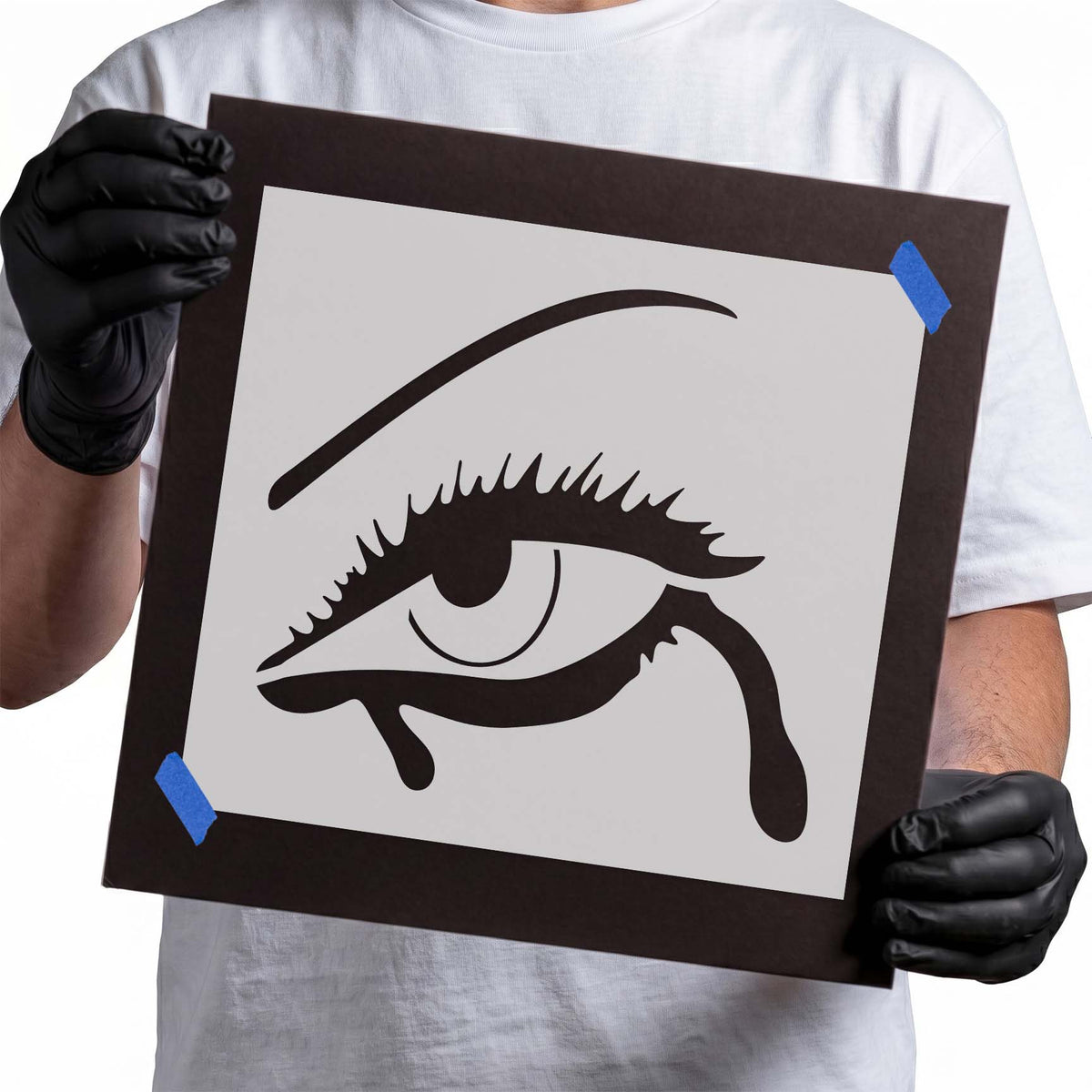 Detailed eye with makeup stencil featuring lashes, eyebrow, and flowing liner