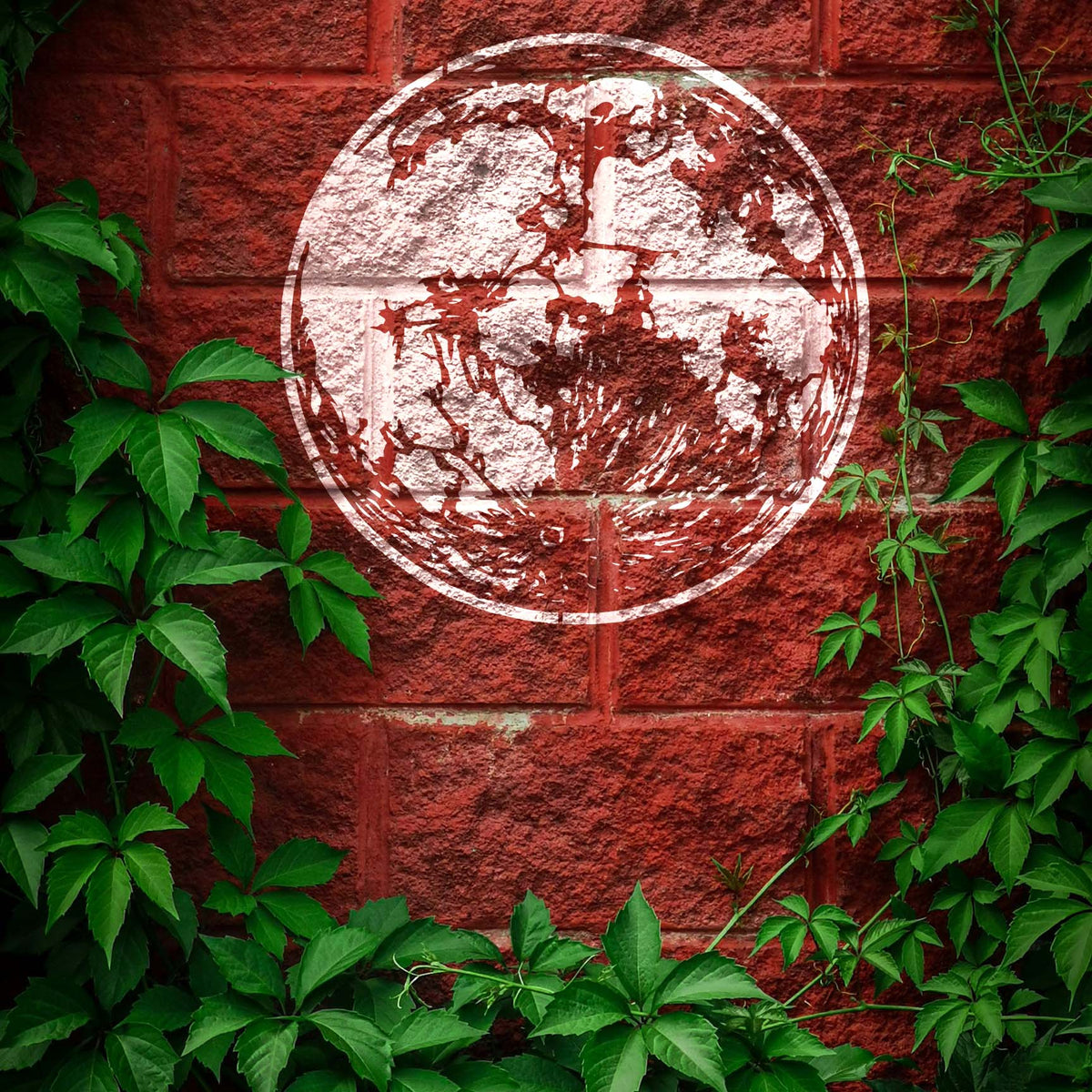 Glowing white against red bricks, the Detailed Full Moon Stencil reveals rugged lunar craters amid vines.