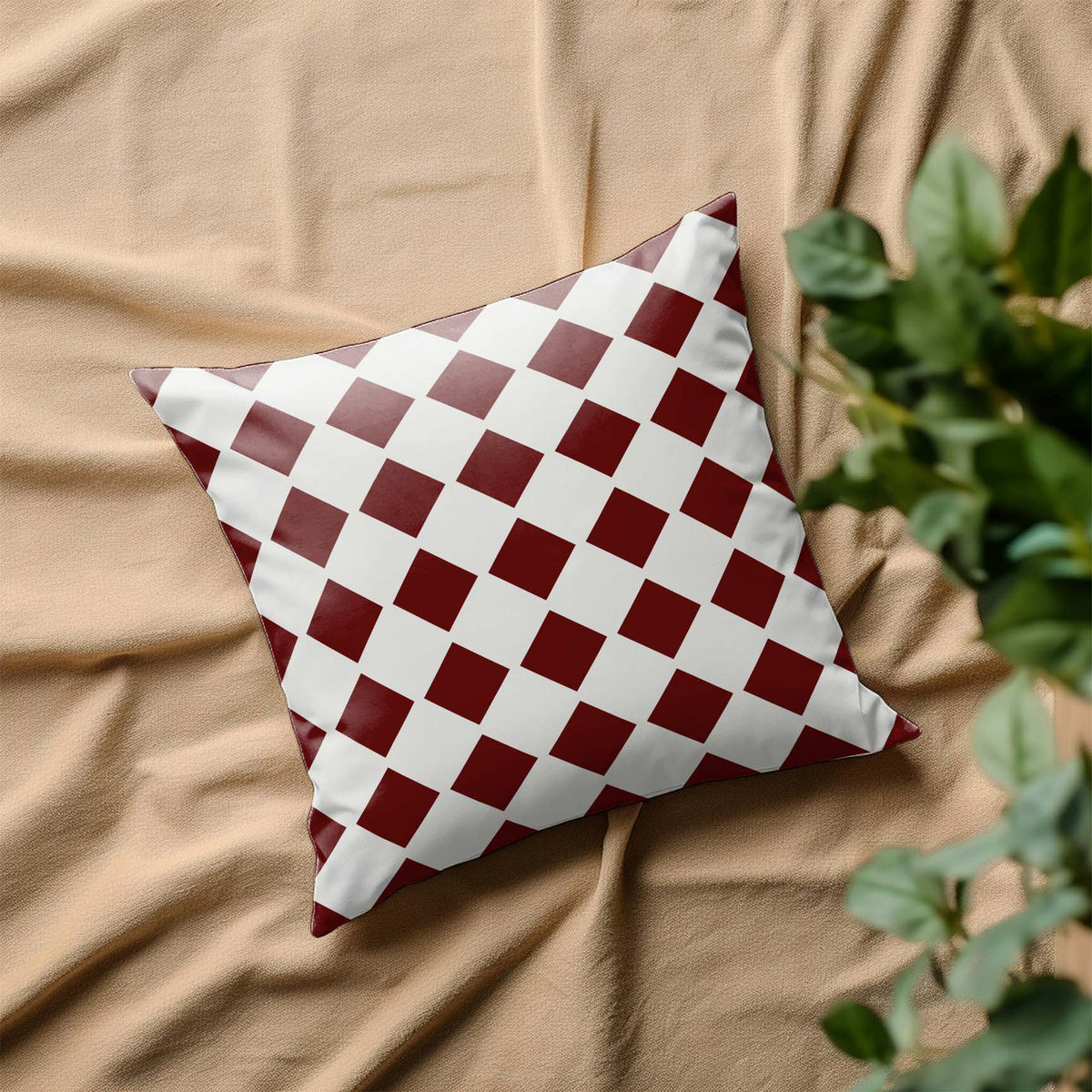 Diagonal Checkerboard Stencil brings a retro burgundy diamond pattern to a white decorative pillow.