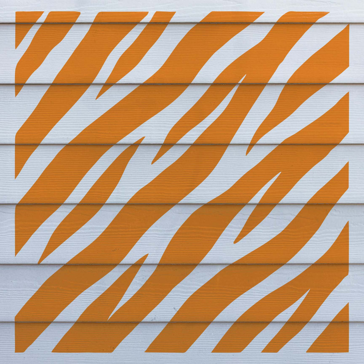 White wood siding features the Diagonal Tiger Stripe Pattern Stencil in warm orange