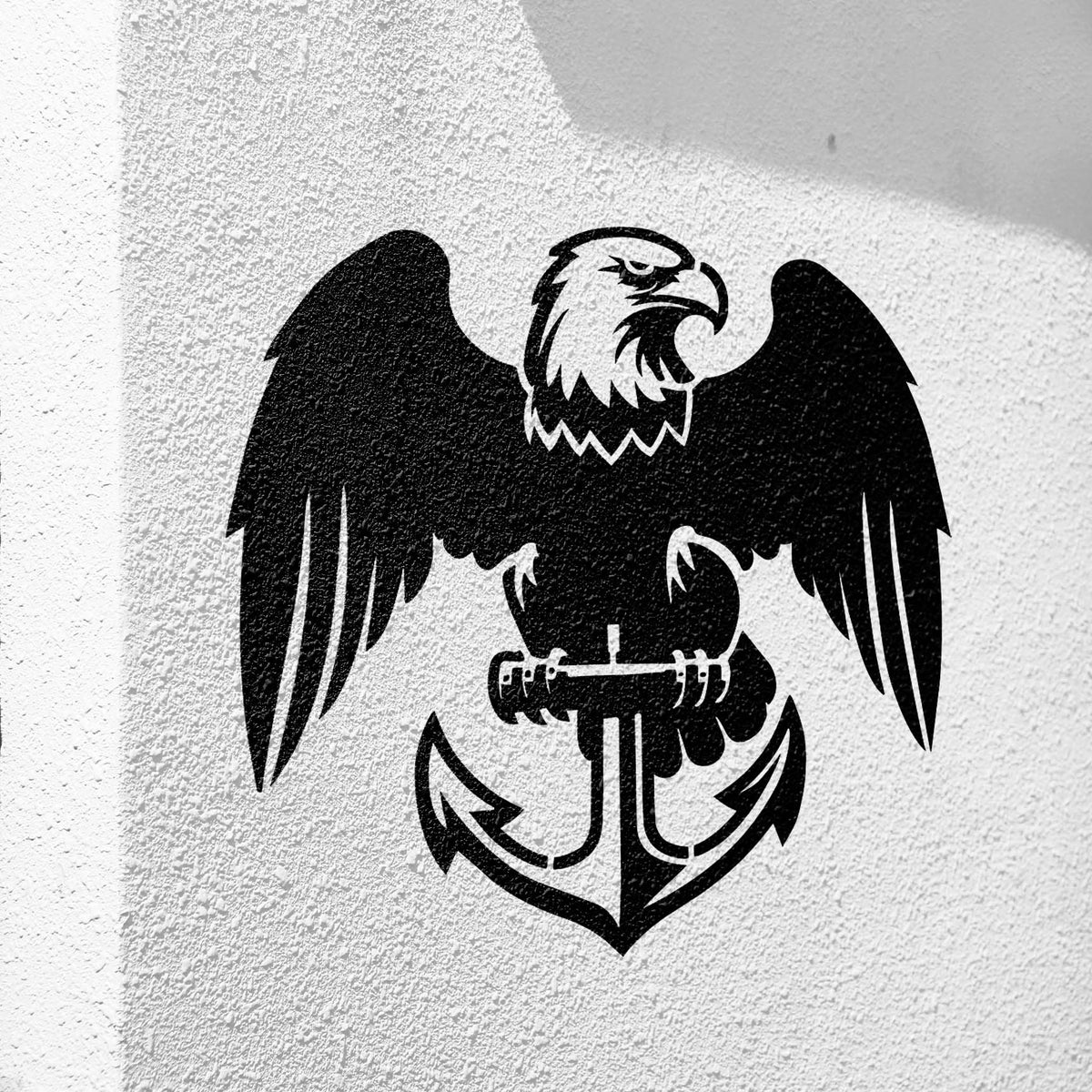 Black Eagle and Anchor Emblem Stencil stands out on a textured white wall with its fierce eagle and curved anchor.