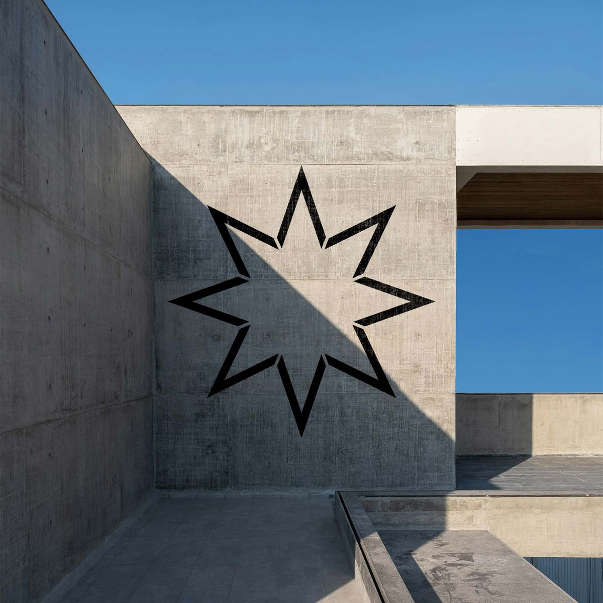 Architectural concrete wall features the Eight-Point Star Outline Stencil in bold black