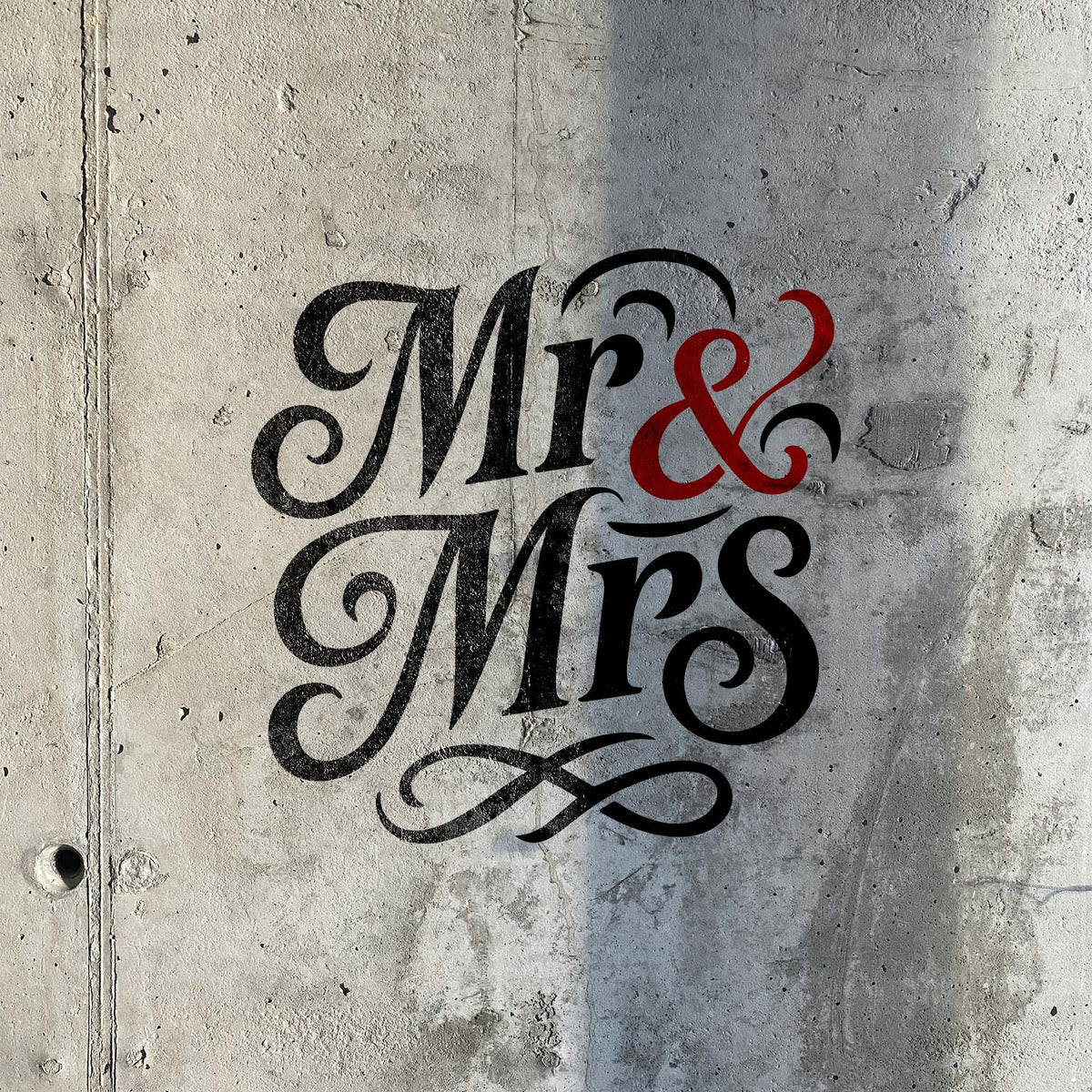 Elegant Mr & Mrs script stencil painted on textured concrete