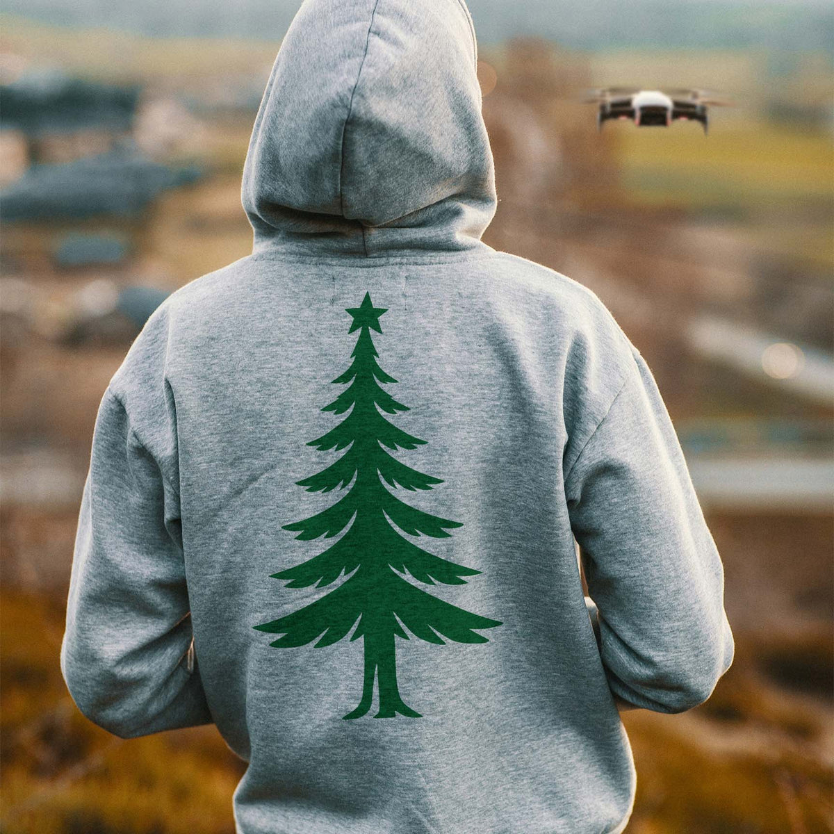 Back of a gray hoodie printed with the Elegant Slim Christmas Tree Stencil in green.